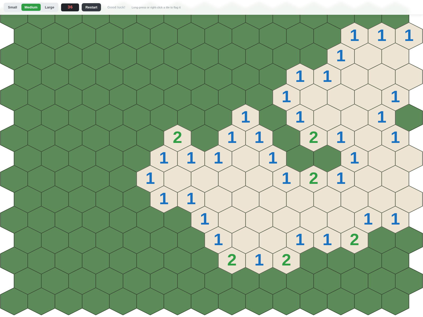 A hexagonal minesweeper board with a large pocket of cells uncovered, showing colour-coded neighbour counts and a live mine counter in the toolbar.